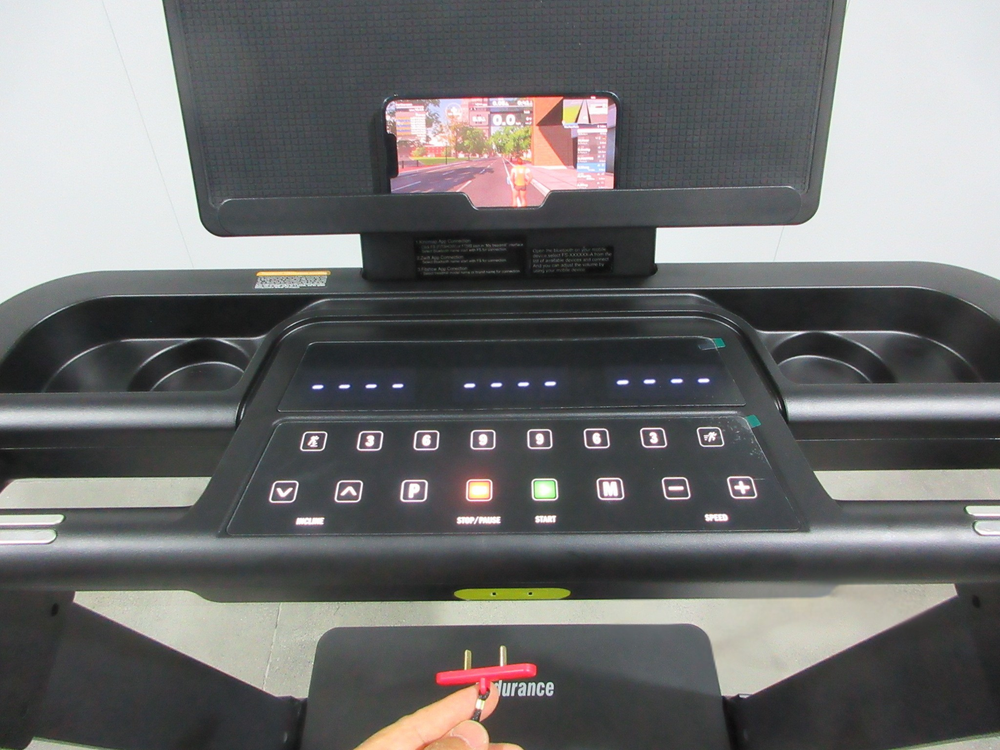 Endurance SPT treadmill console with digital display, control buttons, and a phone holder.
